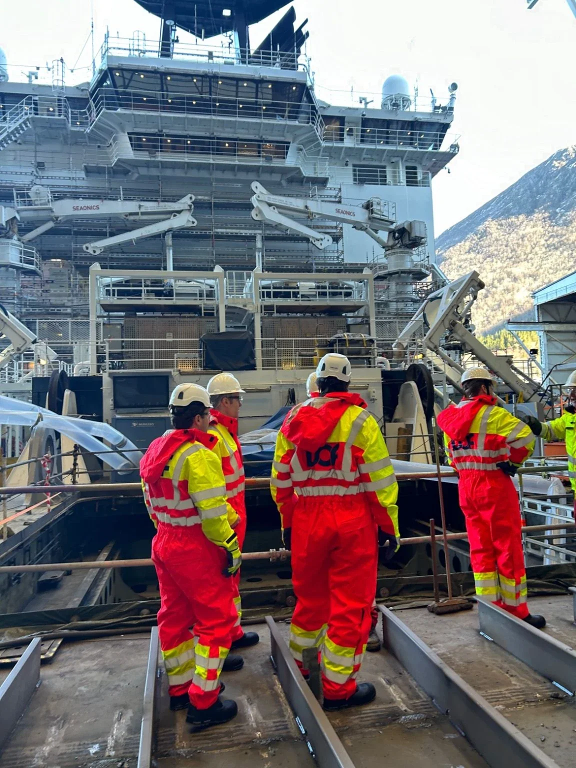 Visitors in safety equipment on board a DOF vessel.